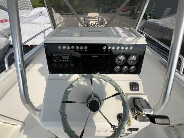 Slide: The Image of Console of a 2001 Carolina Skiff 2100 boat with steering wheel and gauges. - 8