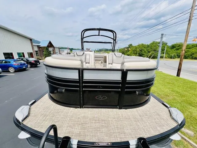 Slide: The Image of 2018 Harris Grand Mariner SEL 250 pontoon boat on trailer, parked outdoors. - 11