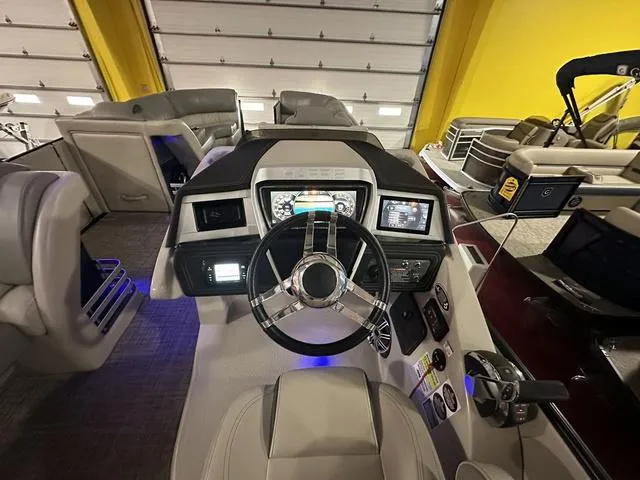 Slide: The Image of 2018 Harris Grand Mariner SEL 250 boat dashboard with modern controls and steering wheel. - 13