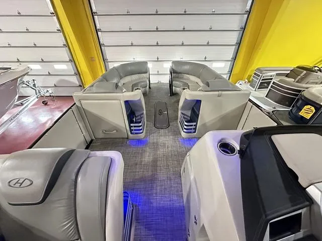 Slide: The Image of 2018 Harris Grand Mariner SEL 250 boat interior with gray seating and blue LED lighting. - 15