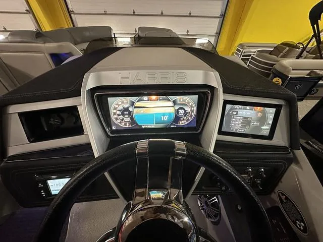 Slide: The Image of 2018 Harris Grand Mariner SEL 250 dashboard with digital displays and steering wheel. - 16