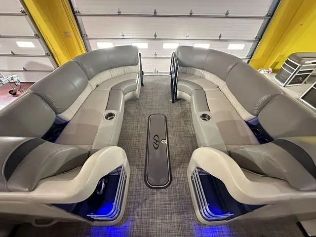 Slide: The Image of Interior of 2018 Harris Grand Mariner SEL 250 pontoon boat with plush seating and blue lighting. - 19