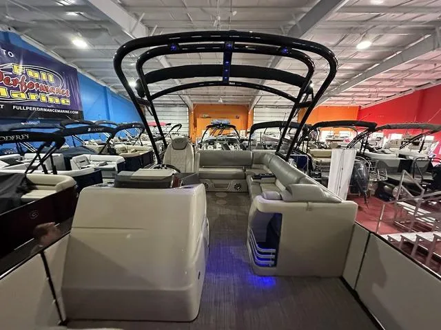 Slide: The Image of 2018 Harris Grand Mariner SEL 250 pontoon boat in showroom, featuring spacious seating and modern design. - 24