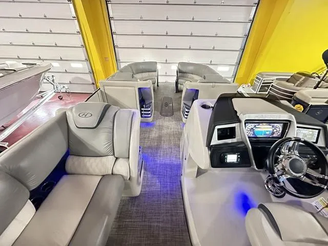 Slide: The Image of 2018 Harris Grand Mariner SEL 250 boat interior with plush seating and modern dashboard. - 25