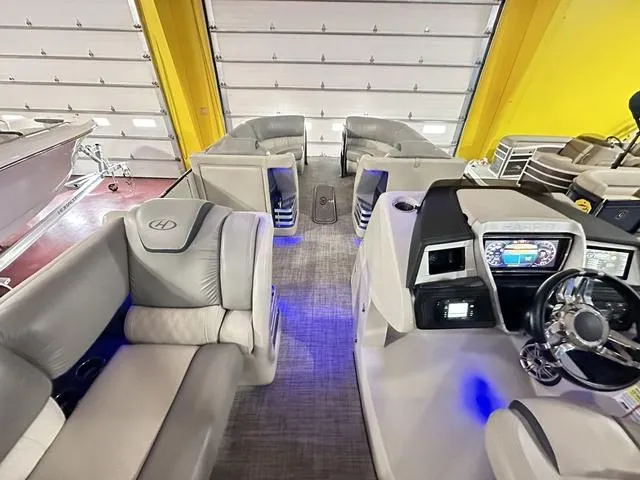 Slide: The Image of 2018 Harris Grand Mariner SEL 250 boat interior with plush seating and modern dashboard. - 30