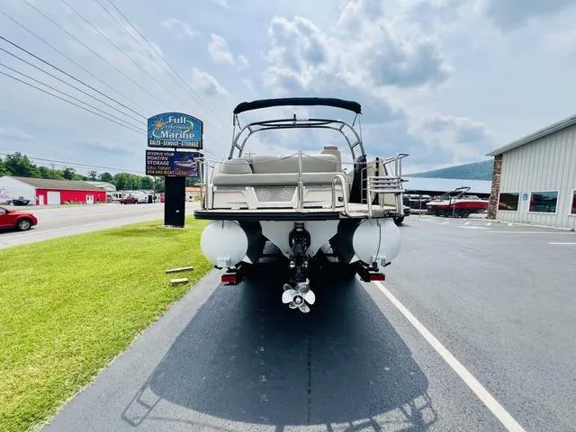 Slide: The Image of 2018 Harris Grand Mariner SEL 250 boat parked at a marina under cloudy skies. - 5