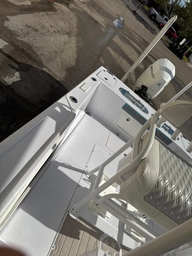 Slide: The Image of 1986 Mako 224 CC boat interior with seating and motor. - 10