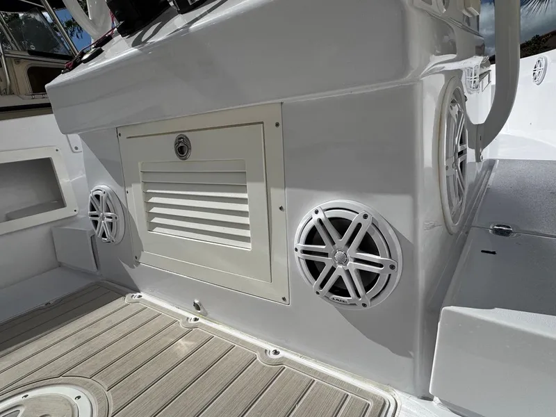 Slide: The Image of 1986 Mako 224 CC boat interior with speakers and storage compartment. - 14