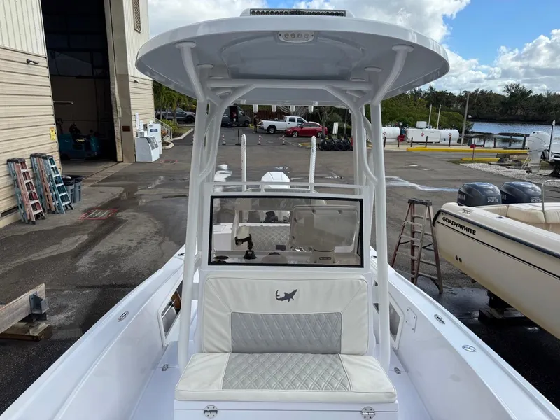 Slide: The Image of 1986 Mako 224 CC boat with T-top, docked at marina. - 17