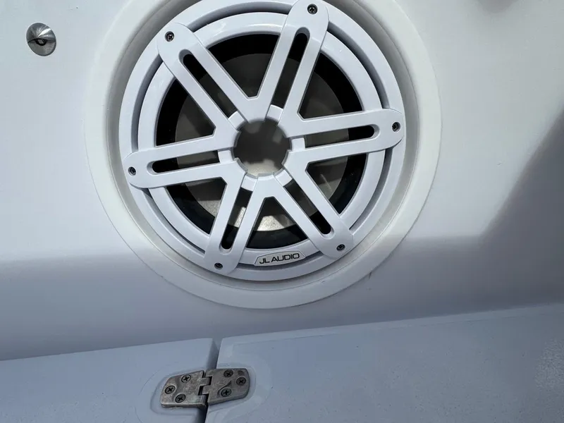 Slide: The Image of White JL Audio speaker on 1986 Mako 224 CC boat interior. - 21