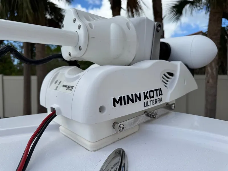 Slide: The Image of Minn Kota Ulterra trolling motor on 1986 Mako 224 CC boat, palm trees in background. - 24