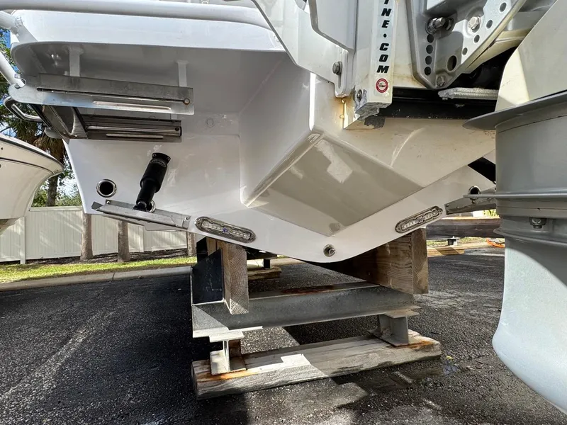 Slide: The Image of 1986 Mako 224 CC boat hull on wooden supports, viewed from the rear. - 28