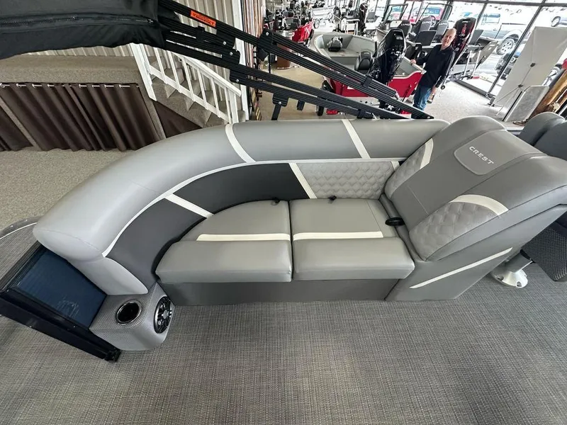 Slide: The Image of 2025 Crest Classic 220 SLC 3 Toon boat interior with gray seating and modern design. - 11