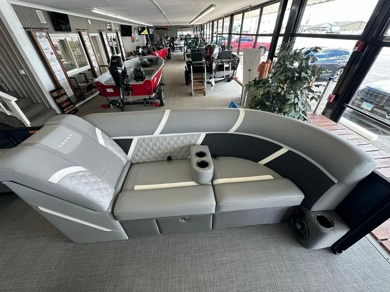 Slide: The Image of 2025 Crest Classic 220 SLC 3 Toon boat interior with gray seating and cup holders. - 3