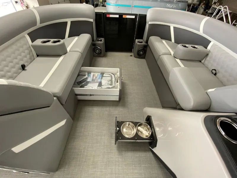 Slide: The Image of 2025 Crest Classic 220 SLSC 3 Toon interior with gray seating and cup holders. - 3