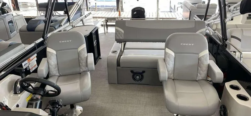 Slide: The Image of 2025 Crest Classic 220 SLSC 3 Toon interior with plush seating and modern design. - 4