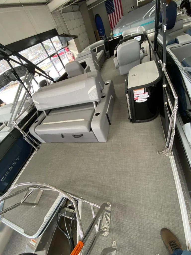 Slide: The Image of 2025 Crest Classic 220 SLSC 3 Toon pontoon boat interior with seating and helm. - 6