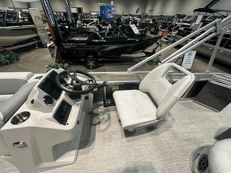 Slide: The Image of Interior of 2025 Avalon 2185 Venture CR boat at a showroom display. - 6