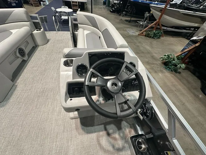 Slide: The Image of Interior view of 2025 Avalon 2185 Venture CR boat, featuring steering wheel and seating. - 7