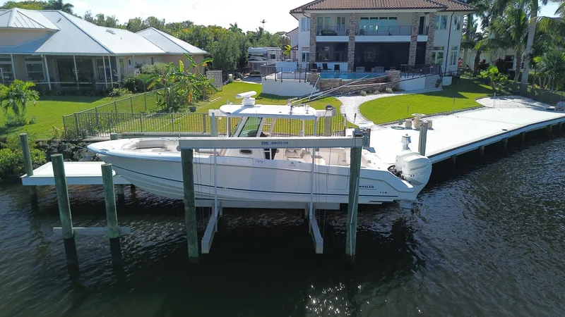 Slide: The Image of 2017 Boston Whaler 330 Outrage docked by waterfront home. - 1
