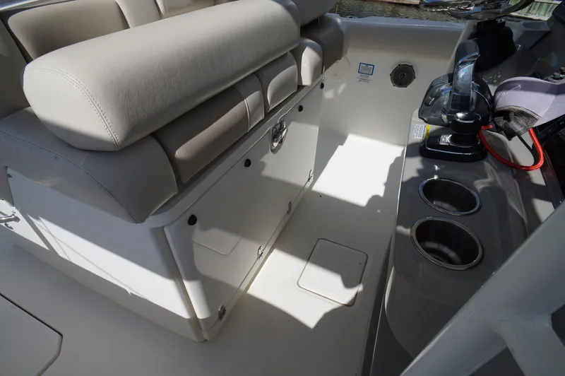 Slide: The Image of 2017 Boston Whaler 330 Outrage interior with seating and storage compartments. - 10