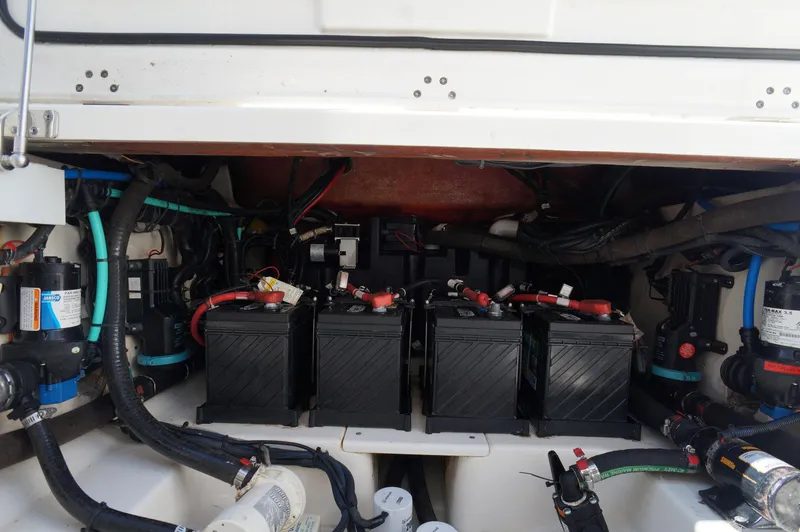 Slide: The Image of 2017 Boston Whaler 330 Outrage engine compartment with batteries and wiring. - 12