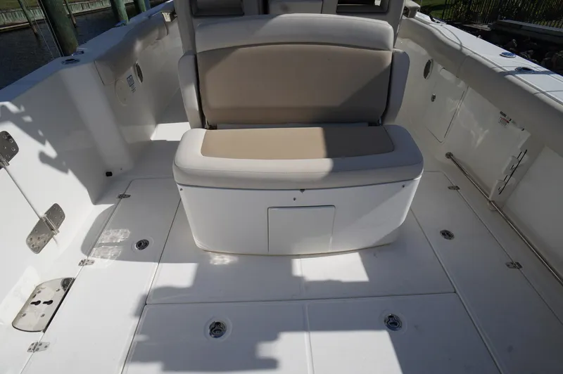 Slide: The Image of 2017 Boston Whaler 330 Outrage boat interior with cushioned seating. - 13
