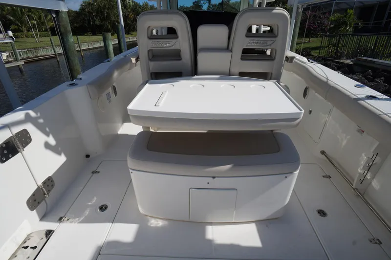 Slide: The Image of 2017 Boston Whaler 330 Outrage boat interior with seating and table. - 14