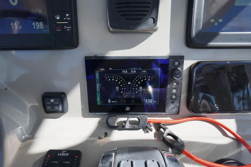 Slide: The Image of Control panel of 2017 Boston Whaler 330 Outrage boat with digital display and gauges. - 17