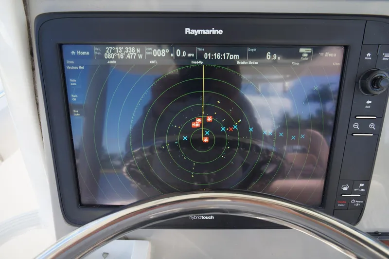 Slide: The Image of Raymarine navigation display on 2017 Boston Whaler 330 Outrage boat, showing radar and GPS data. - 19