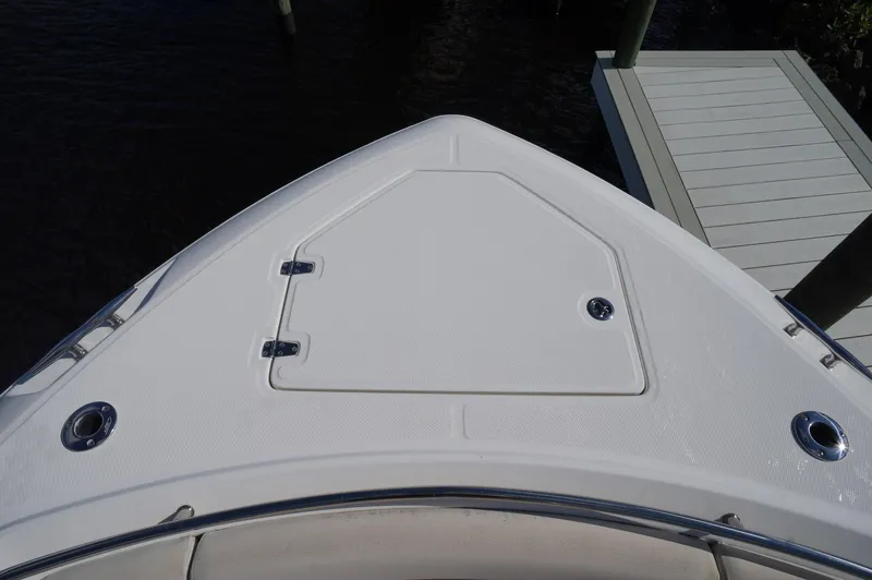 Slide: The Image of 2017 Boston Whaler 330 Outrage boat bow with storage hatch, docked. - 23