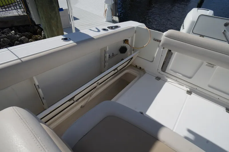 Slide: The Image of 2017 Boston Whaler 330 Outrage boat interior with seating and storage compartments. - 25