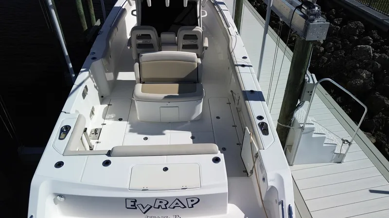 Slide: The Image of 2017 Boston Whaler 330 Outrage boat interior with seating and deck view. - 27