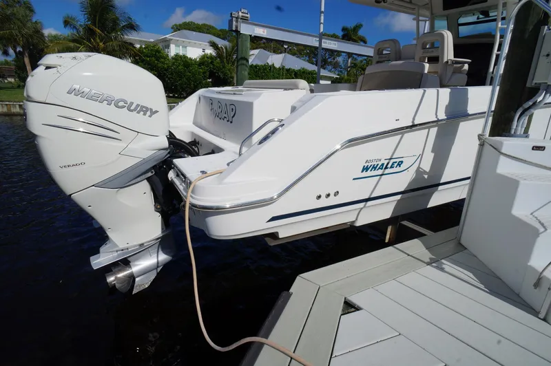 Slide: The Image of 2017 Boston Whaler 330 Outrage with Mercury engine docked by the water. - 3