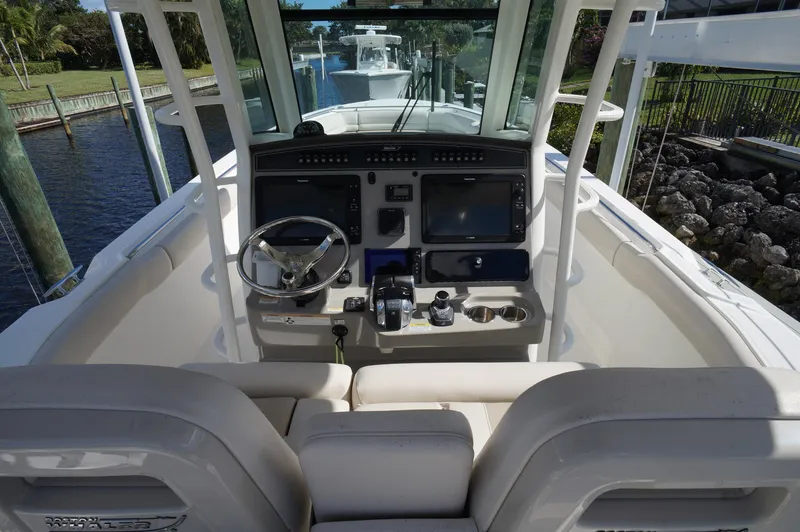 Slide: The Image of 2017 Boston Whaler 330 Outrage helm with dual screens and steering wheel. - 5