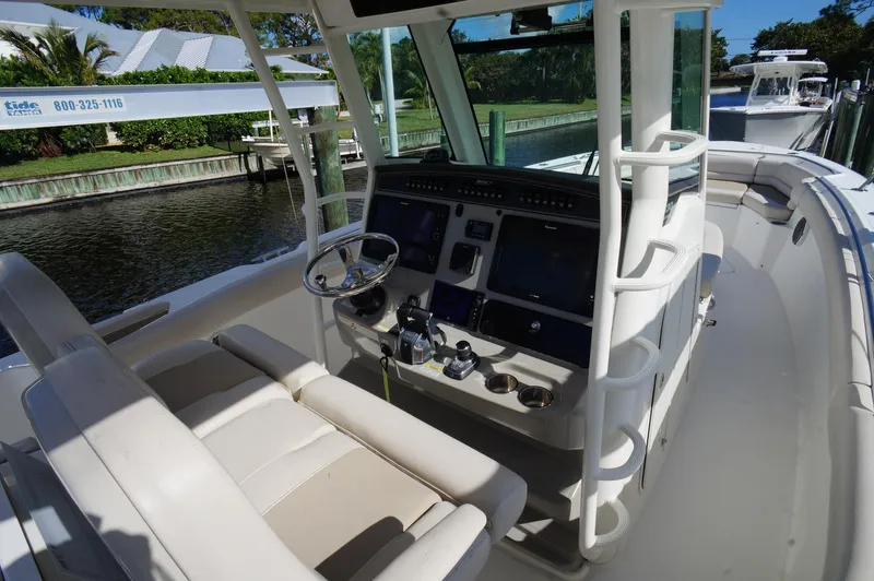 Slide: The Image of 2017 Boston Whaler 330 Outrage helm with modern controls and seating. - 6