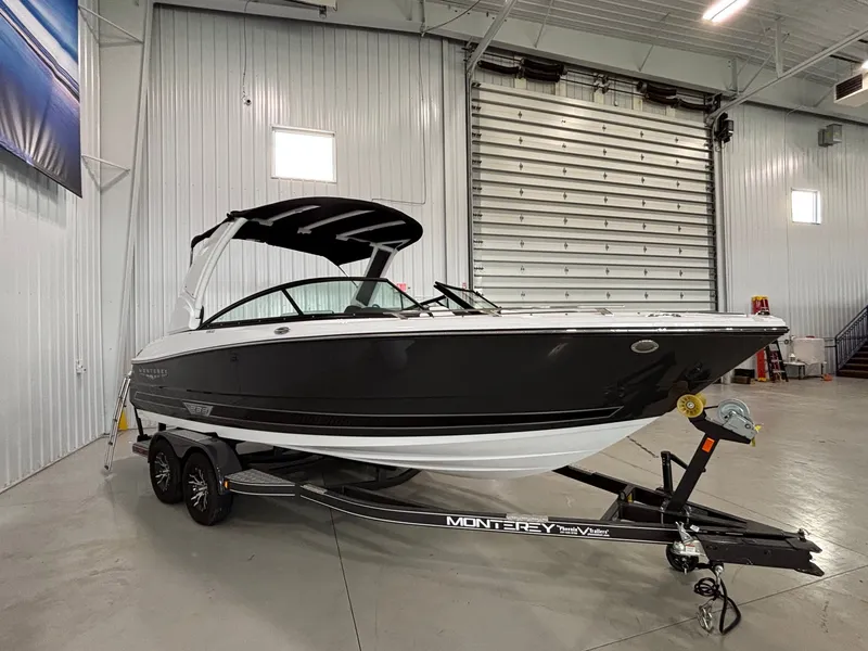 The Image of 2025 Monterey 238SS Luxury Bowrider in showroom, black and white design on trailer. - 0