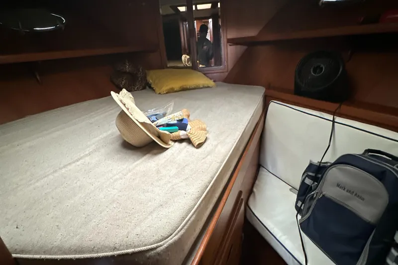 Slide: The Image of Cozy cabin interior of 1988 Marine Trader Trawler with bed and personal items. - 11