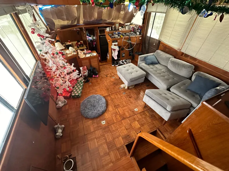 Slide: The Image of Cozy 1988 Marine Trader Trawler interior with festive decor and comfortable seating. - 6