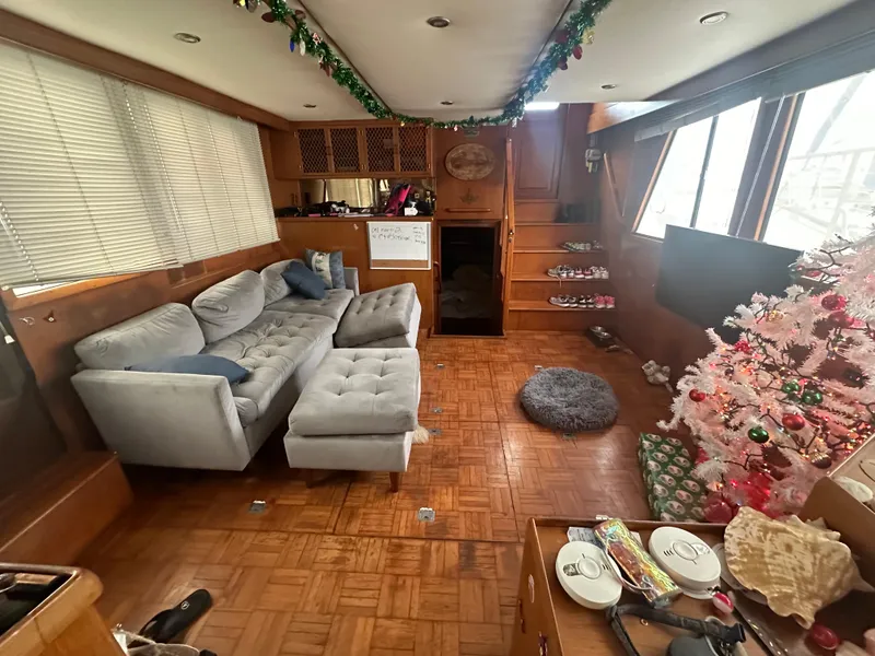 Slide: The Image of Cozy 1988 Marine Trader Trawler interior with sofa, Christmas tree, and festive decorations. - 7