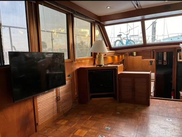 Slide: The Image of Interior of 1988 Marine Trader Trawler with wood paneling, TV, and lamp. - 8