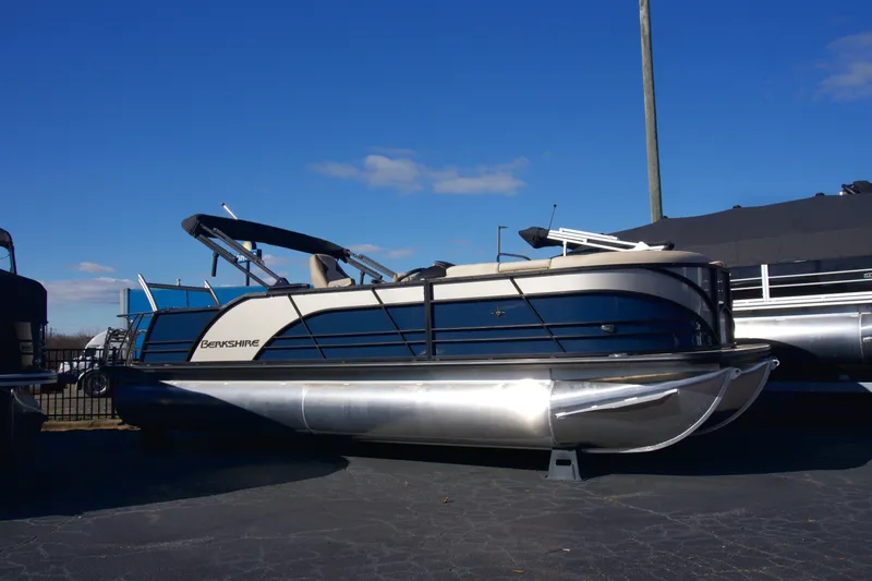 The Image of 2024 Berkshire 23ULSTS3-93 pontoon boat on display under clear blue sky. - 0