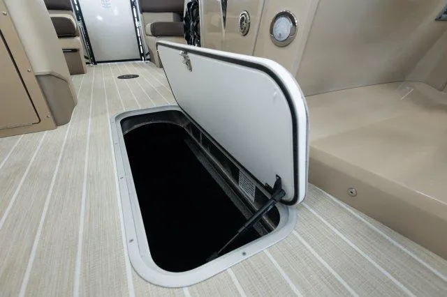 Slide: The Image of 2024 Berkshire 23ULSTS3-93 boat storage compartment with open hatch on deck. - 12