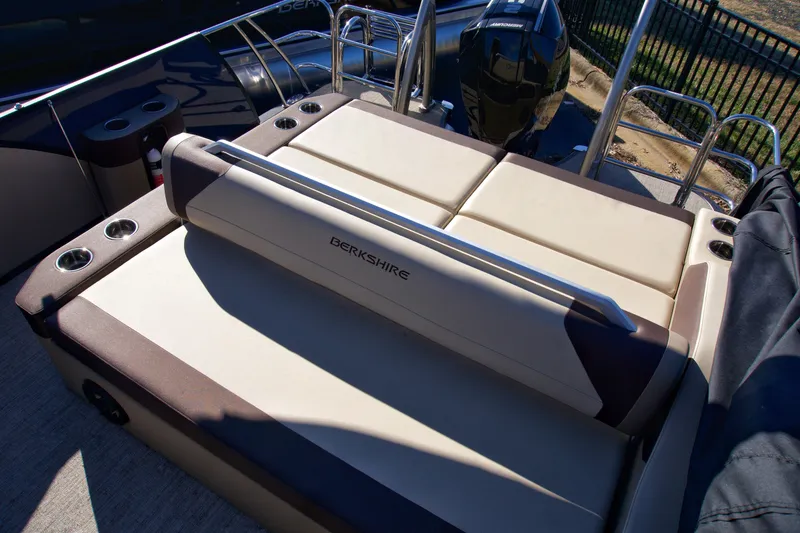Slide: The Image of 2024 Berkshire 23ULSTS3-93 boat with beige seating and cup holders. - 4