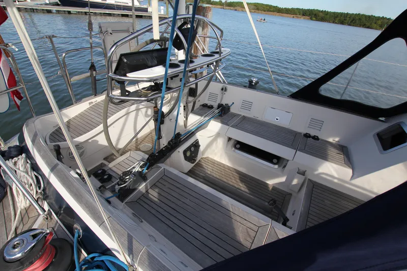 Slide: The Image of Cockpit of 2001 Nautor Swan 44MKII sailboat with steering wheel, docked by calm waters. - 14