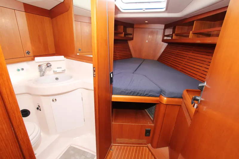Slide: The Image of Luxurious cabin interior of 2001 Nautor Swan 44MKII yacht with wood finish and cozy bed. - 27