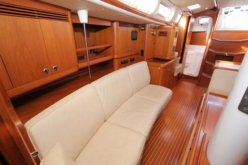 Slide: The Image of Luxurious interior of 2001 Nautor Swan 44MKII yacht with wooden finishes and beige seating. - 30