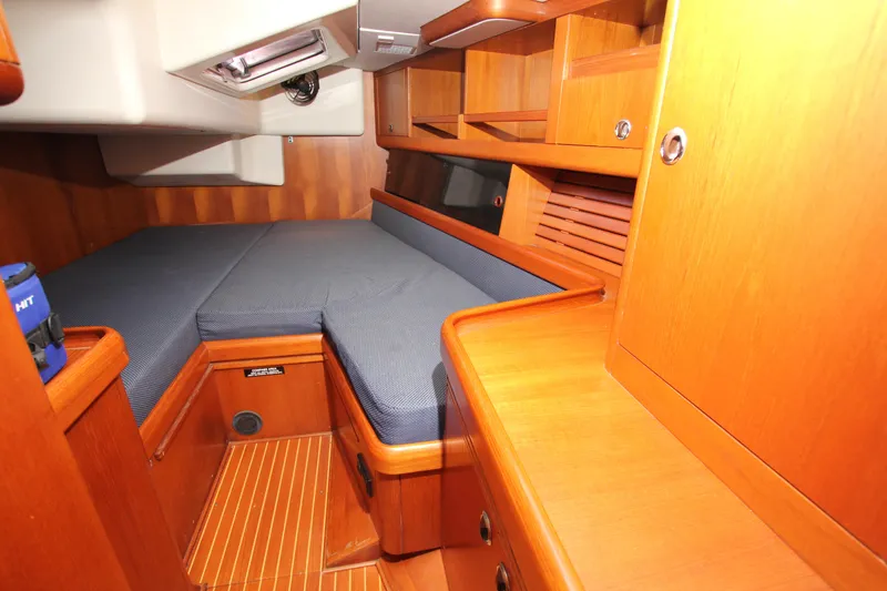Slide: The Image of Cozy cabin interior of 2001 Nautor Swan 44MKII yacht with wooden furnishings and blue bedding. - 40