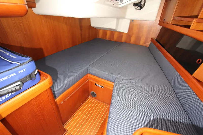 Slide: The Image of Cozy cabin interior of 2001 Nautor Swan 44MKII yacht with wooden finish and blue cushions. - 41