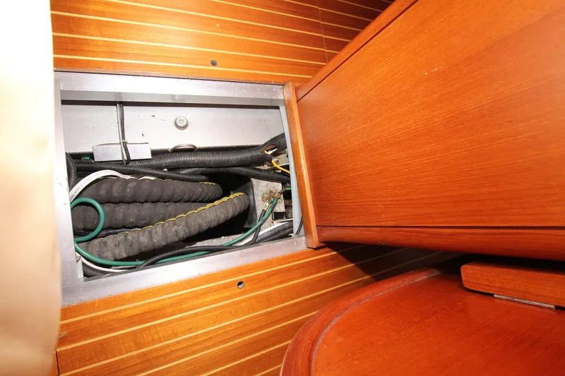 Slide: The Image of Nautor Swan 44MKII 2001 yacht interior wiring compartment with wooden paneling. - 44